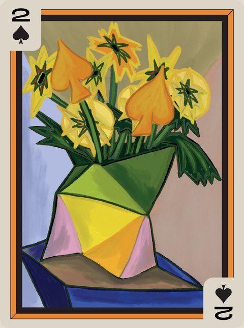 Yellow flowers with spade-shaped petals in a faceted green vase.
